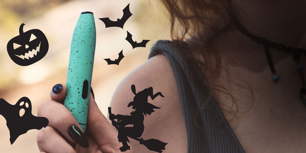 Person with a Halloween-themed stickers, holding a Wulf LX Slim.
